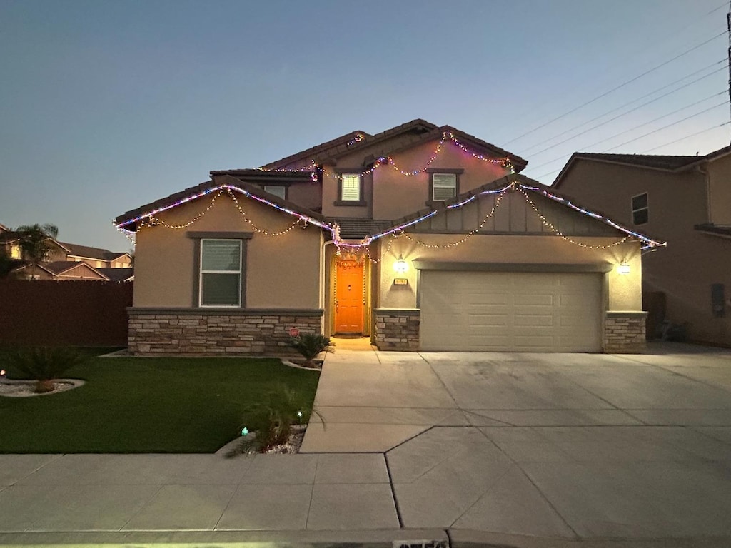 mediterranean / spanish-style home featuring a lawn and a garage