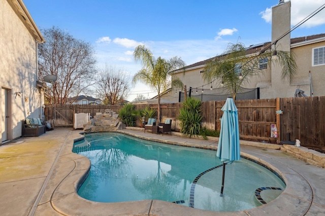 view of swimming pool featuring a patio area