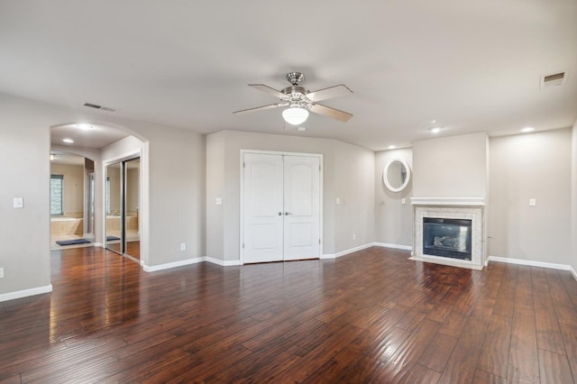 unfurnished living room with ceiling fan and dark wood-type flooring