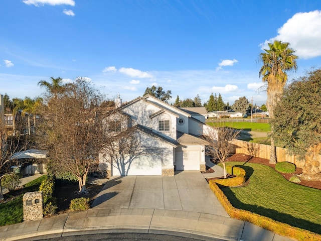 view of front of property with a front lawn and a garage