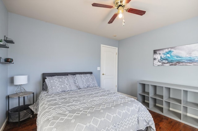 bedroom with ceiling fan and dark hardwood / wood-style flooring