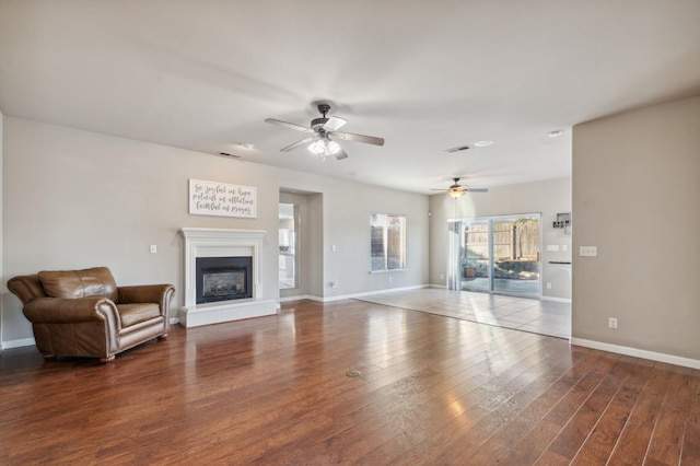 unfurnished living room with ceiling fan and dark hardwood / wood-style floors