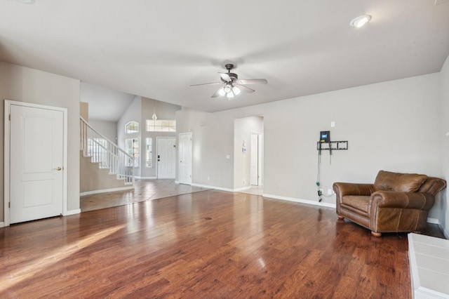 living area with dark hardwood / wood-style flooring and ceiling fan