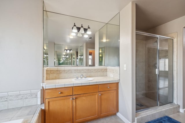 bathroom featuring tile patterned flooring, plus walk in shower, and vanity