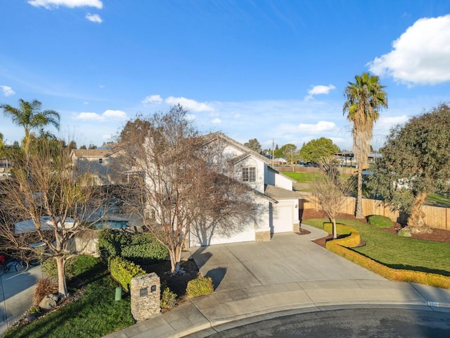 view of front of property with a front yard and a garage