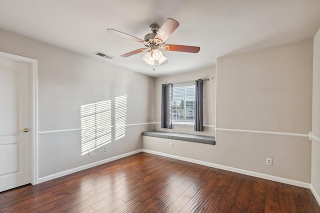 spare room with ceiling fan and dark hardwood / wood-style floors