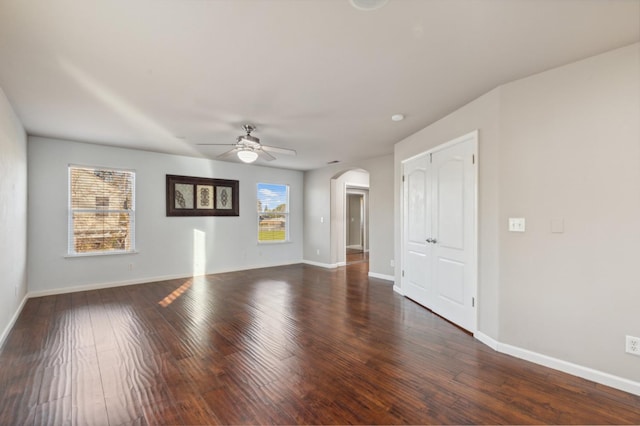 unfurnished room featuring dark hardwood / wood-style flooring and ceiling fan