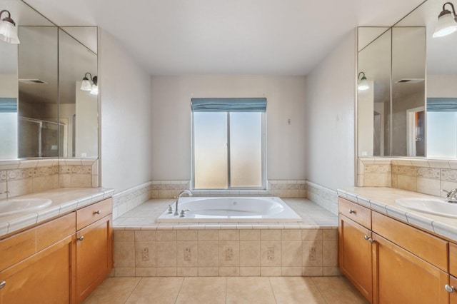 bathroom with tile patterned flooring, shower with separate bathtub, and vanity