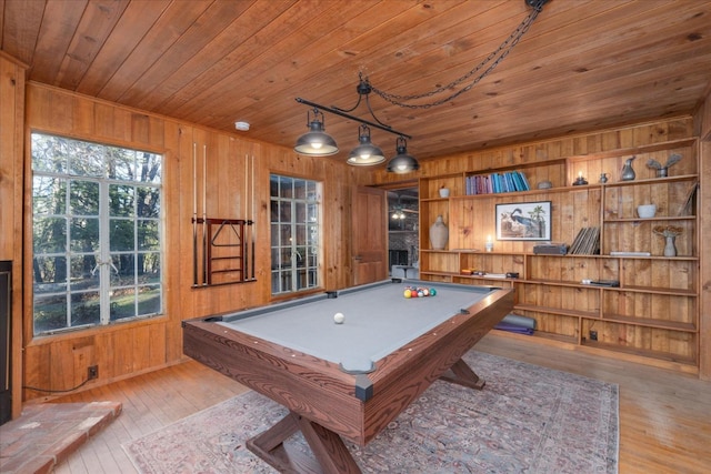 rec room with wooden walls, billiards, wood ceiling, and light hardwood / wood-style flooring