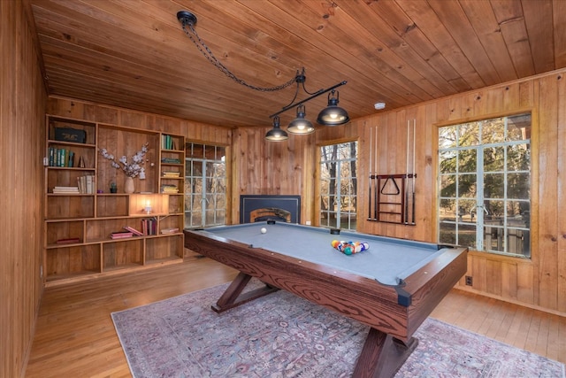 playroom with wooden walls, pool table, light wood-type flooring, and wood ceiling