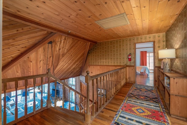 hall featuring wooden ceiling, lofted ceiling with beams, and hardwood / wood-style flooring