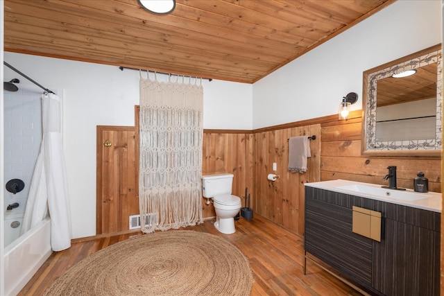 full bathroom with toilet, hardwood / wood-style flooring, wooden walls, and wooden ceiling