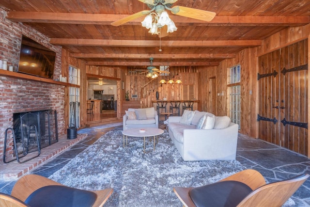 living room featuring beam ceiling, wooden walls, and wooden ceiling