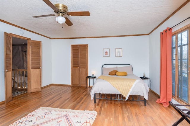 bedroom with wood-type flooring, a closet, ceiling fan, and ornamental molding