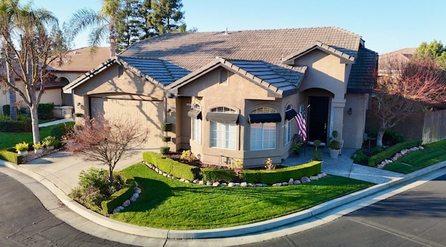 view of front of property with a front lawn and a garage