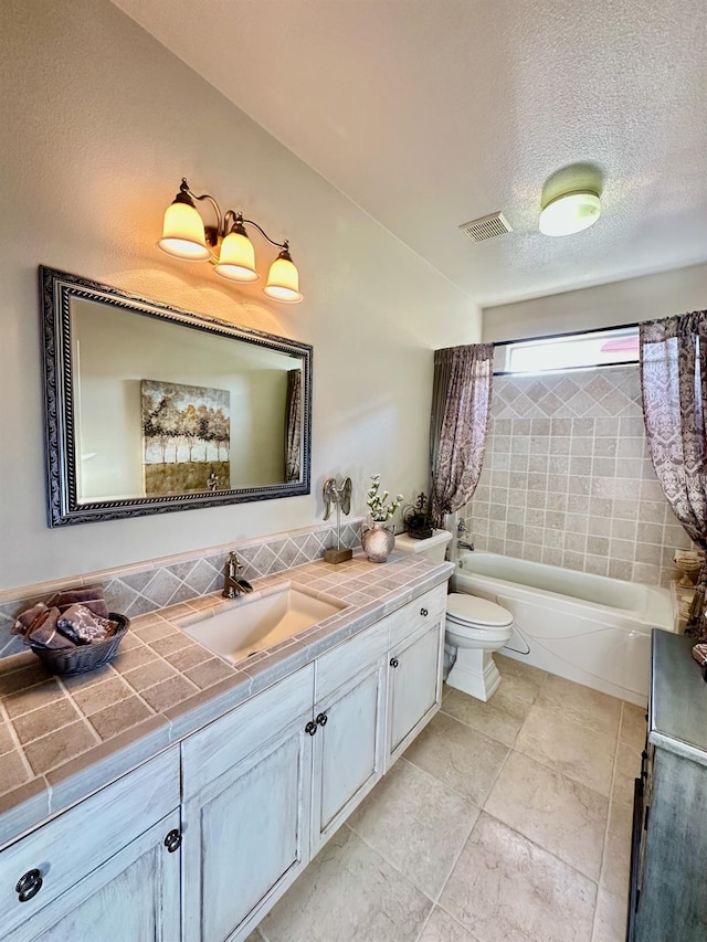 full bathroom featuring toilet, a textured ceiling, washtub / shower combination, and vanity