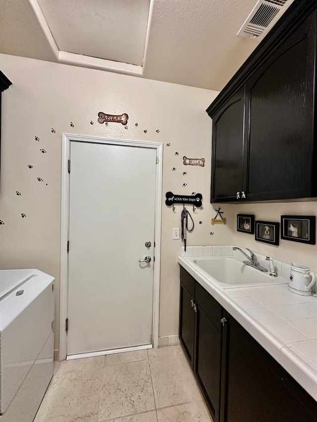 washroom featuring sink and cabinets