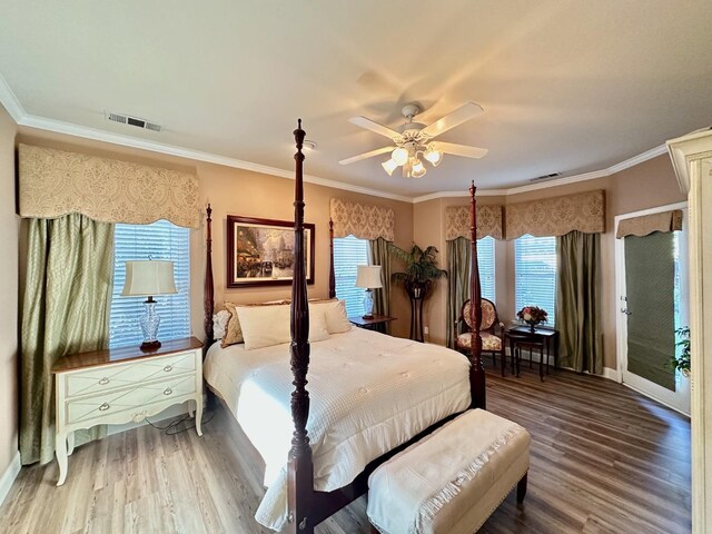 bedroom with ceiling fan, crown molding, and hardwood / wood-style flooring