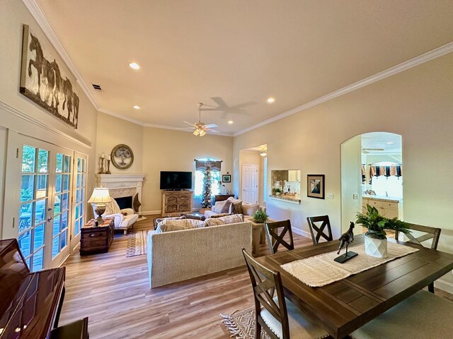 dining room with ceiling fan, light hardwood / wood-style flooring, french doors, and a wealth of natural light