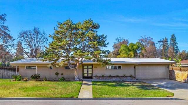 ranch-style home featuring a front yard and a garage