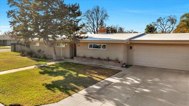 ranch-style home with a front lawn and a garage