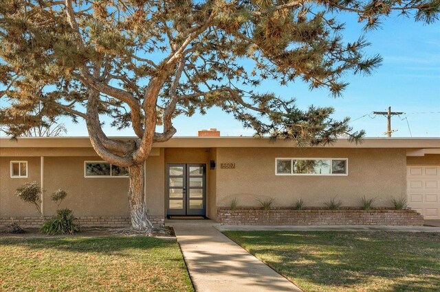 view of front of property with a garage and a front lawn