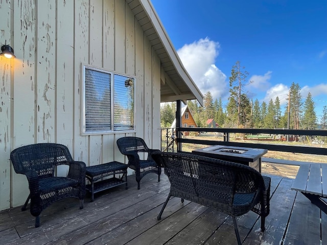 deck featuring an outdoor fire pit