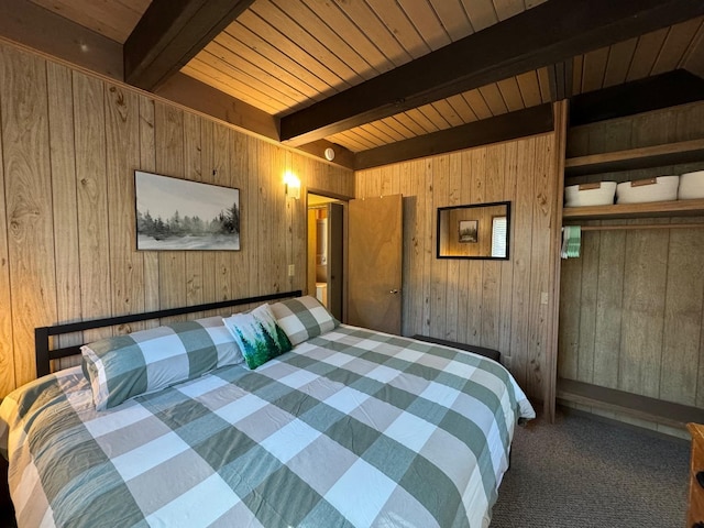 bedroom featuring wood walls, a closet, wood ceiling, beamed ceiling, and dark carpet