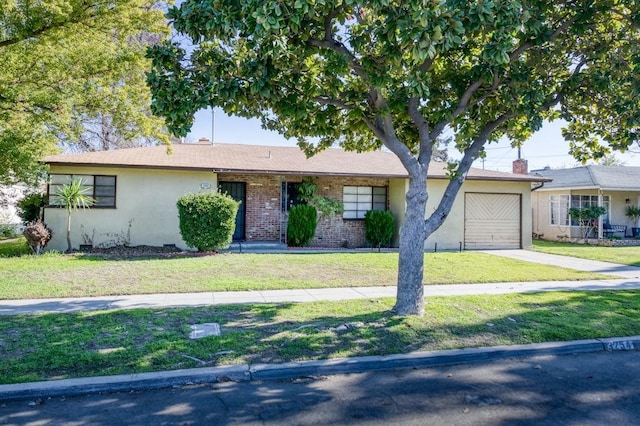 single story home featuring a front lawn and a garage