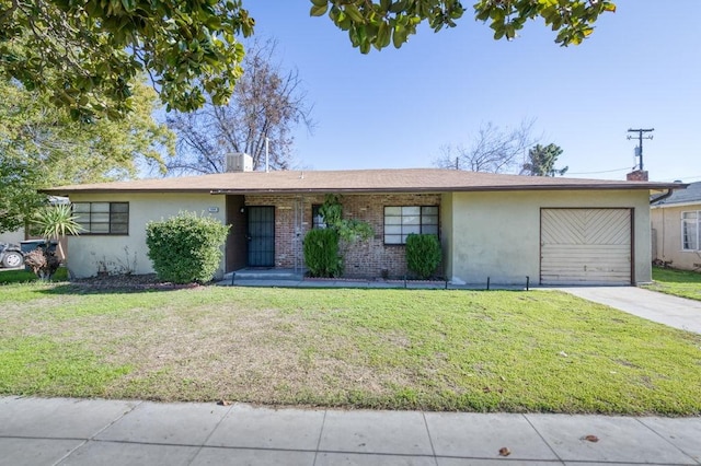 single story home with a front yard and a garage