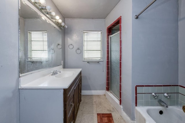 bathroom with separate shower and tub, tile patterned floors, a healthy amount of sunlight, and vanity