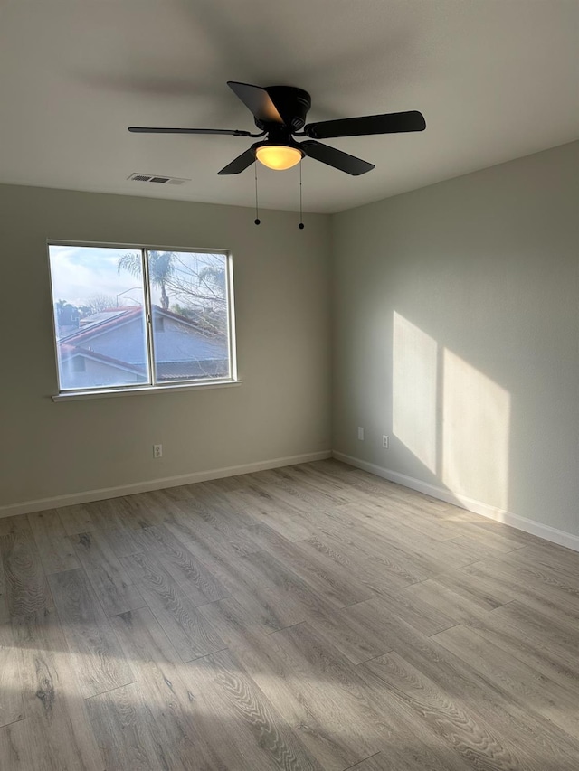 empty room with light hardwood / wood-style floors and ceiling fan