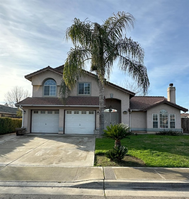 view of front of home with a front yard and a garage