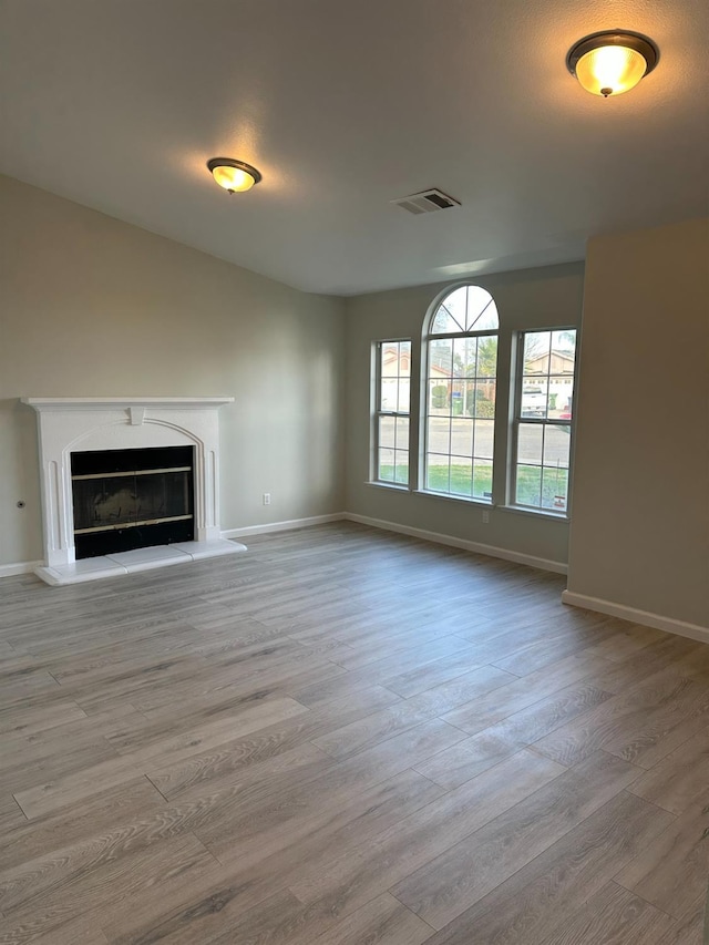 unfurnished living room with light wood-type flooring