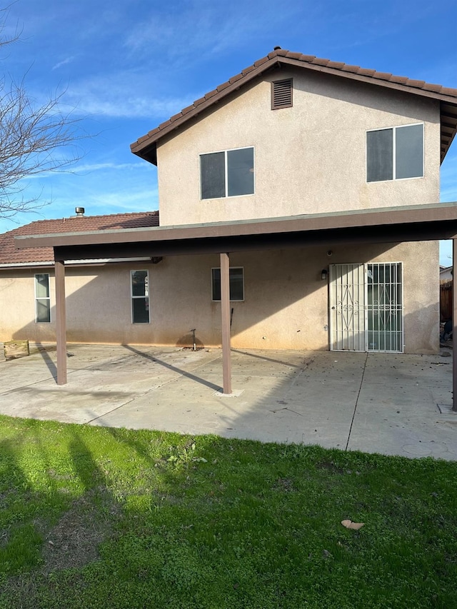 back of property with a patio