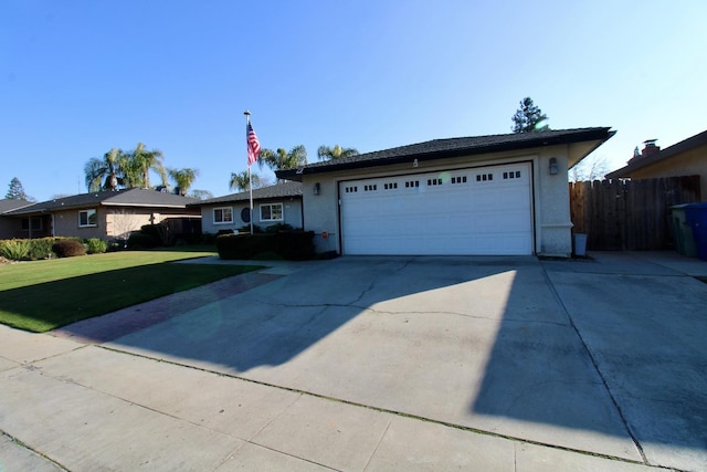 ranch-style home with a front yard and a garage