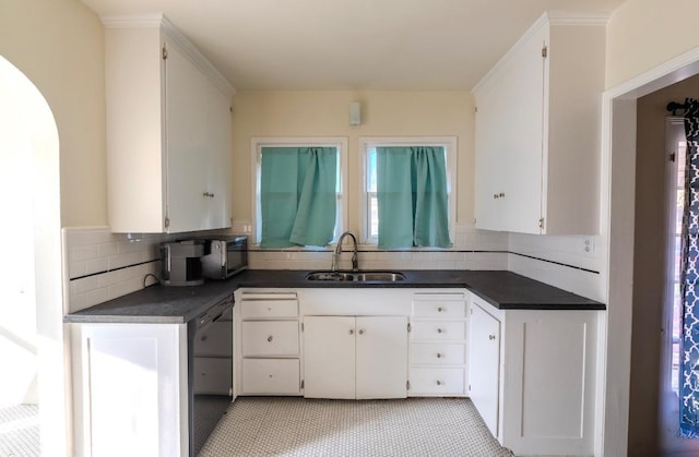 kitchen featuring sink, white cabinetry, decorative backsplash, and light tile patterned floors