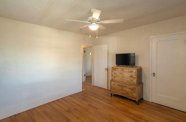 unfurnished bedroom with ceiling fan and light hardwood / wood-style flooring