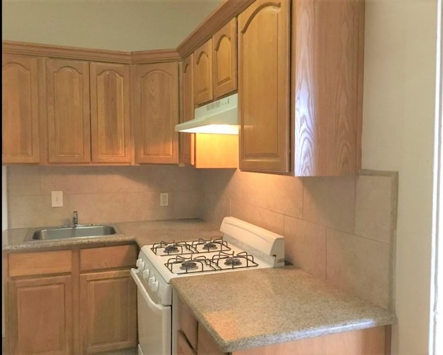 kitchen with sink, decorative backsplash, and white gas stove