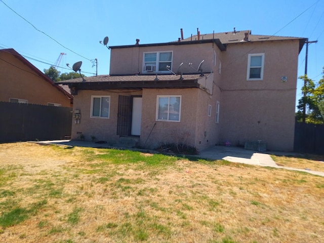 rear view of house featuring a yard and a patio area