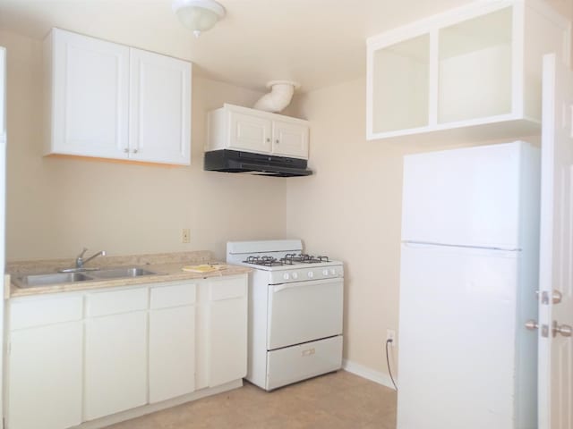 kitchen with white appliances, sink, and white cabinetry