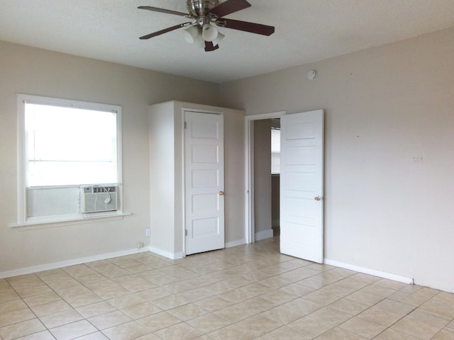 tiled spare room featuring ceiling fan and cooling unit