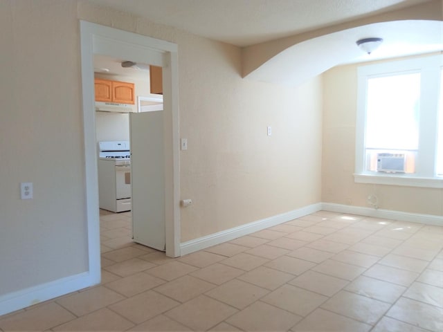 unfurnished room featuring cooling unit and light tile patterned floors