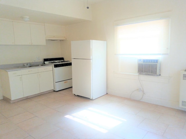 kitchen with white appliances, sink, cooling unit, and white cabinetry