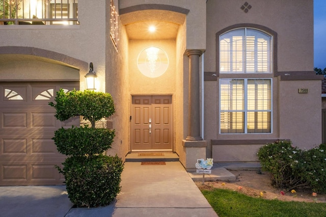 doorway to property with a garage