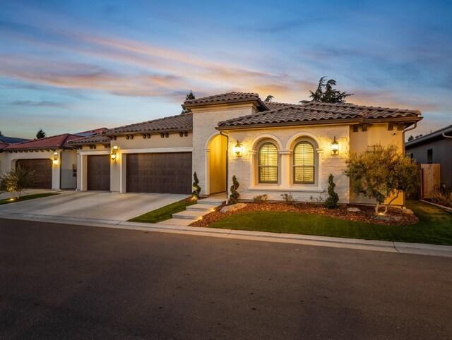 mediterranean / spanish home featuring a garage