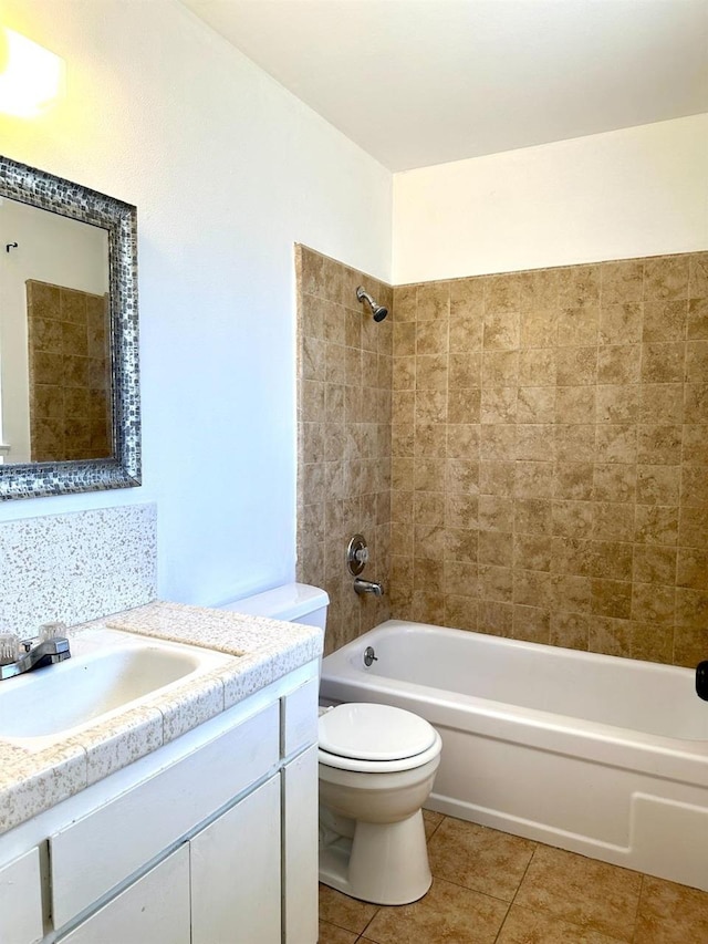 full bathroom with tasteful backsplash, toilet, tile patterned floors, vanity, and tiled shower / bath combo