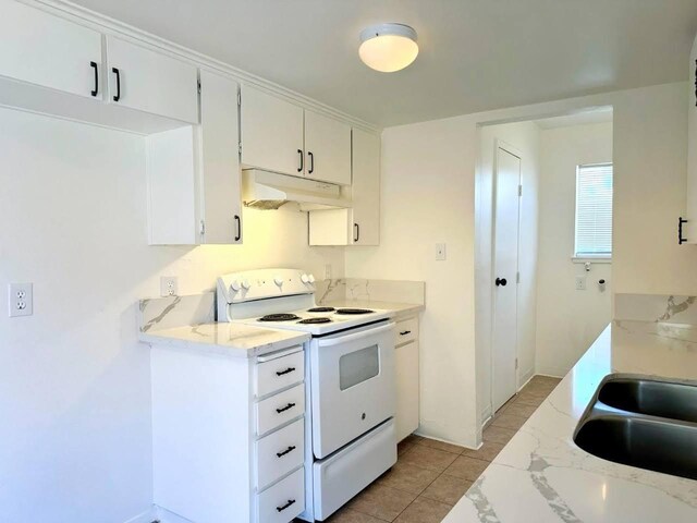 kitchen featuring sink, white cabinetry, light stone counters, and white range with electric stovetop