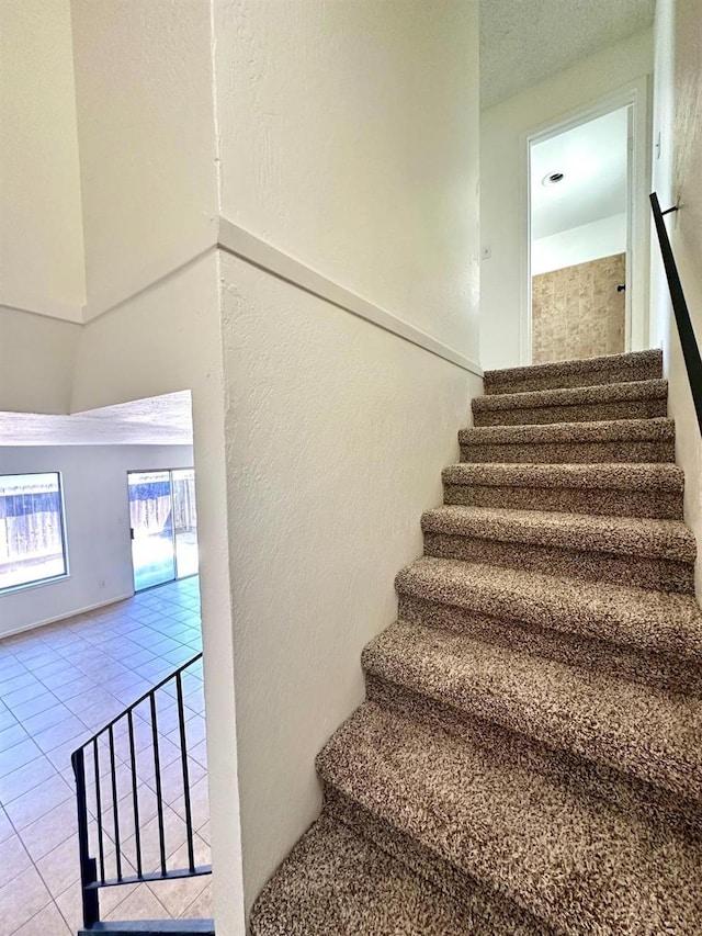 staircase with tile patterned floors