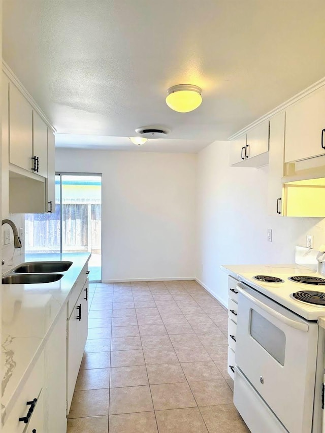 kitchen featuring white range with electric cooktop, white cabinetry, sink, and light tile patterned floors